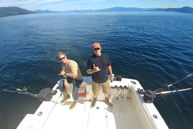 Charter captains pose on board guide boat during a sport fishing trip in Ketchikan