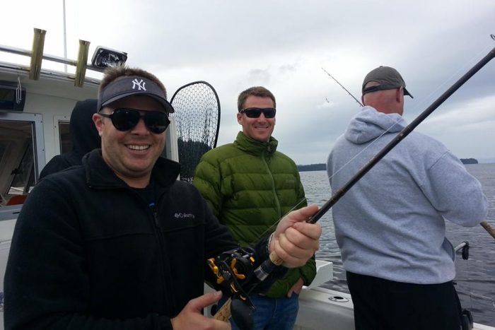 Anglers pose on board charter fishing boat during a guided fishing trip in Ketchikan