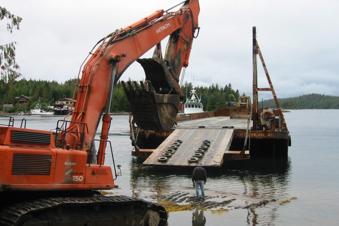 Tug and Equipment Barge for Lodge Construction Construction barge with backhoe and excavator used for development of Chinook Shores Lodge