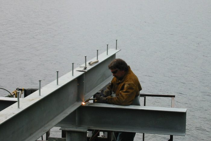 Welder Welder working on dock construction at fishing lodge in Ketchikan Alaska