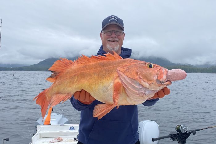 fisherman holds up yelloweye rockfish caught bottomfishing on a guided charter in Ketchikan Alaska