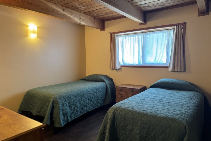 bedroom of cabin at ketchikan fishing lodge showing two twin beds
