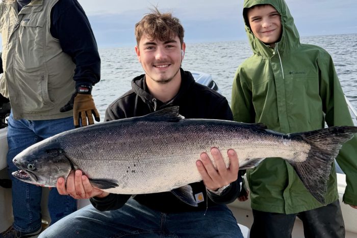Guest poses with king salmon he caught while on a guided charter fishing trip in Ketchikan