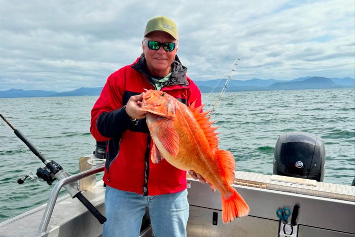 fisherman poses in Silver Streak sport fishing boat with Yelloweye rockfish caught self-guided fishing in Ketchikan