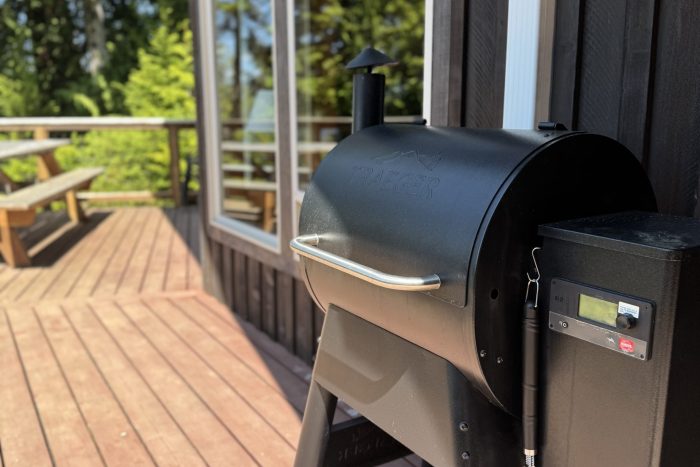 Spacious outdoor deck with traeger grill at a cabin at a fishing lodge in ketchikan