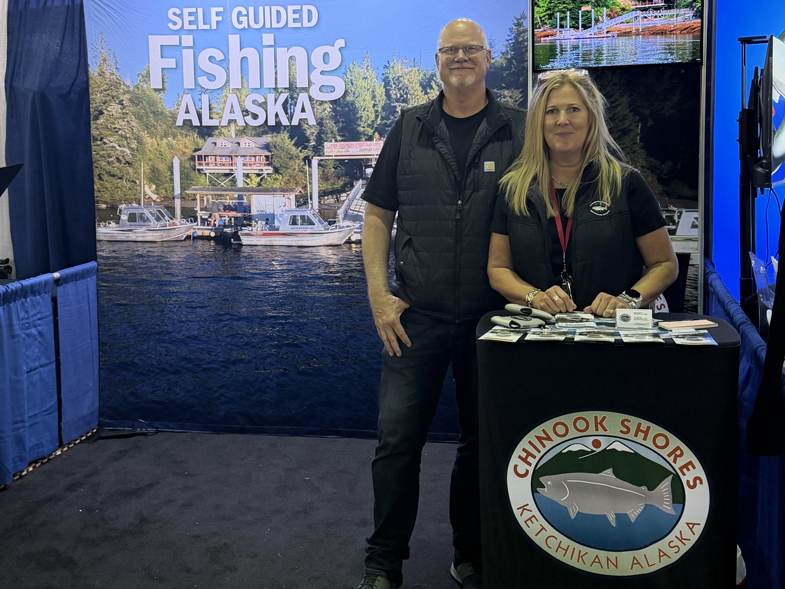 Alaska fishing lodge owners at booth at the International Sportsmen's Expo trade show in Sacramento